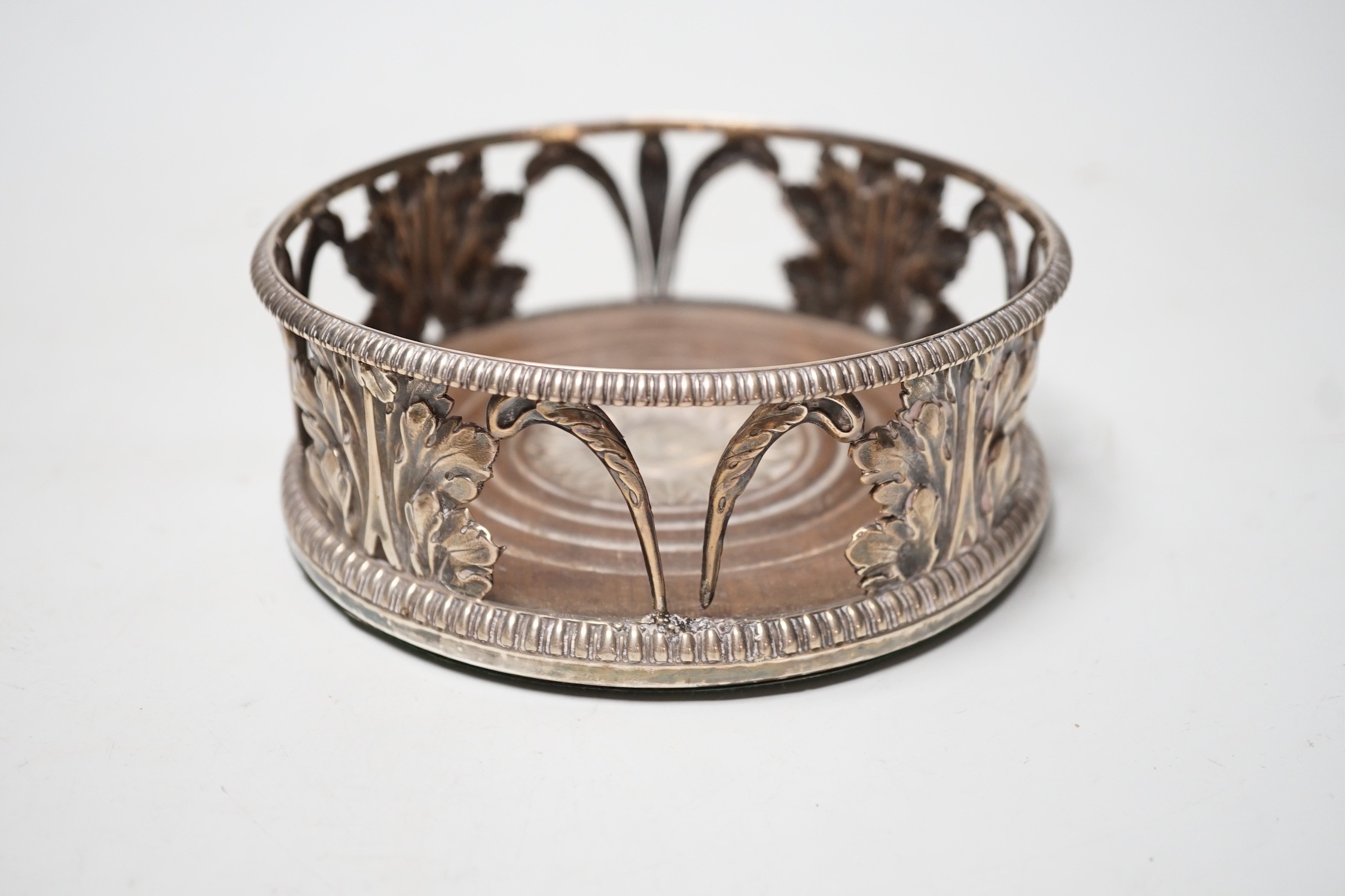 An early 19th century silver mounted wine coaster, marks rubbed, 14cn.